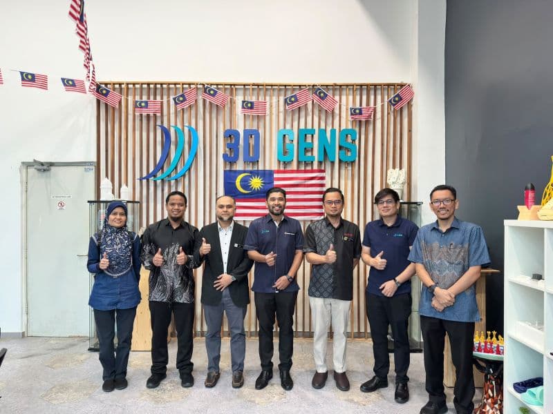 Representatives pose for a group photo in front of the 3D Gens sign
